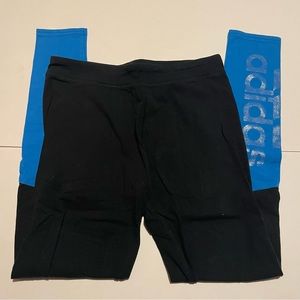 Adidas black athletic leggings with blue color blocks on the legs